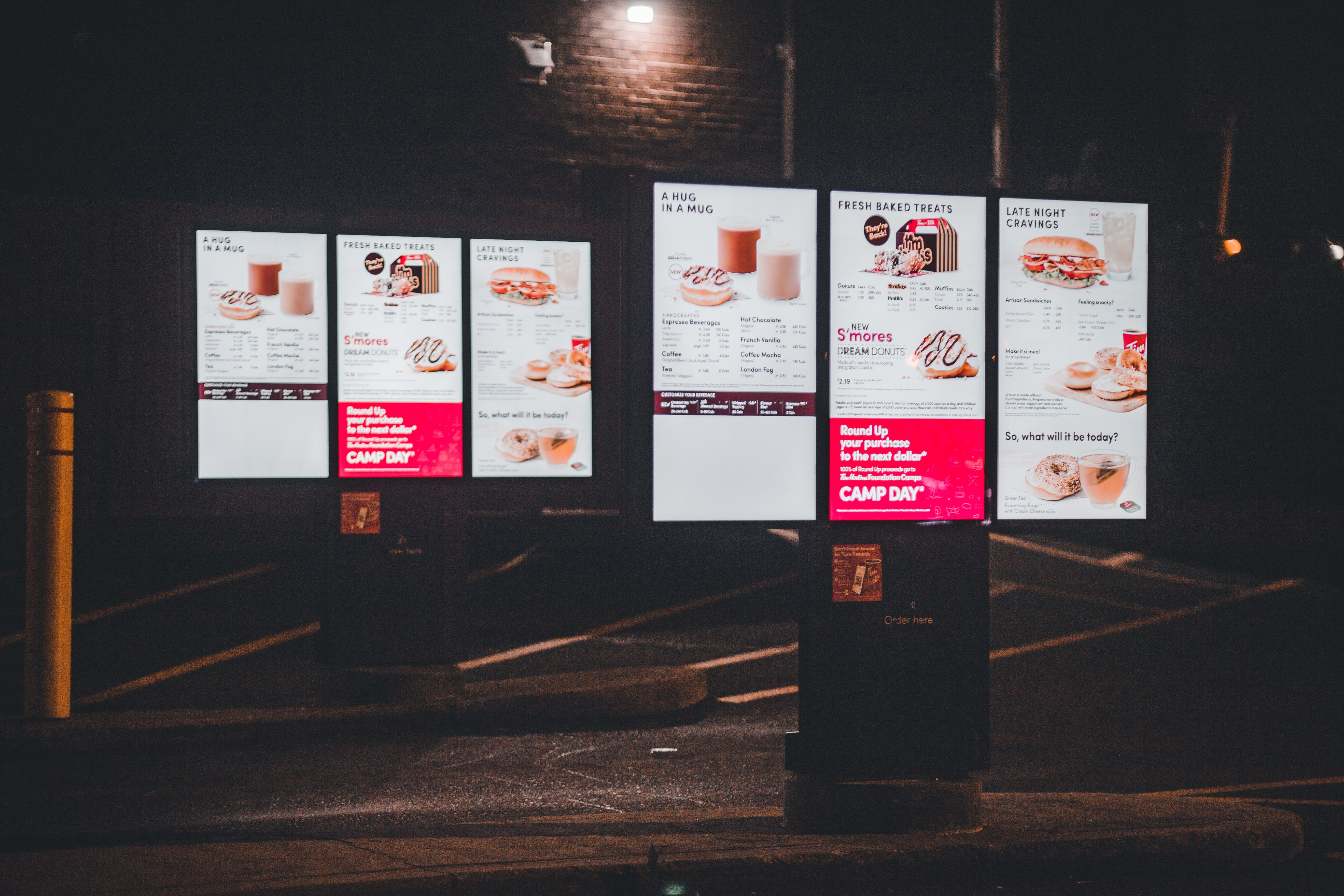 Customer using self-service kiosk touchscreen to order