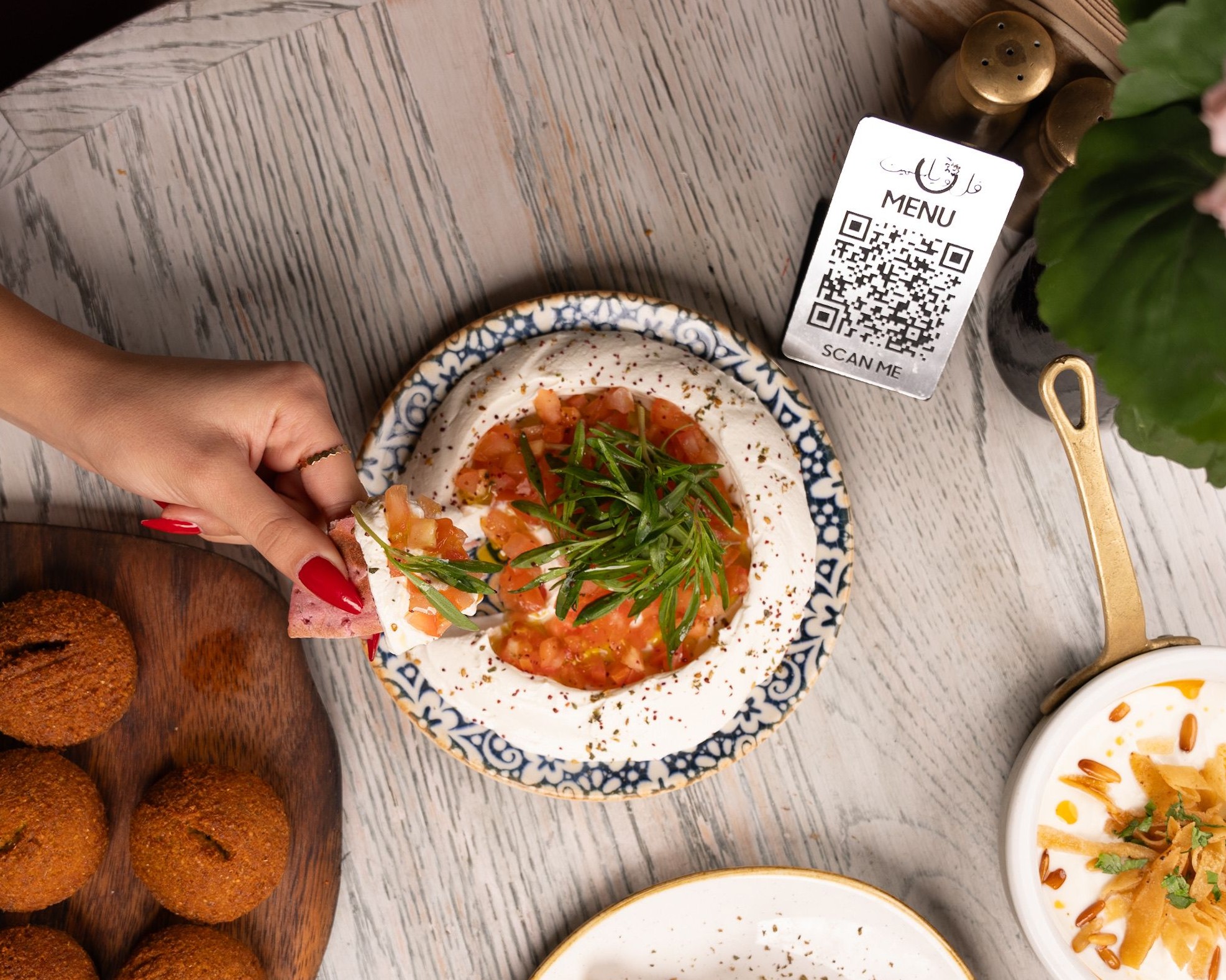 Guest ordering at restaurant table with smartphone